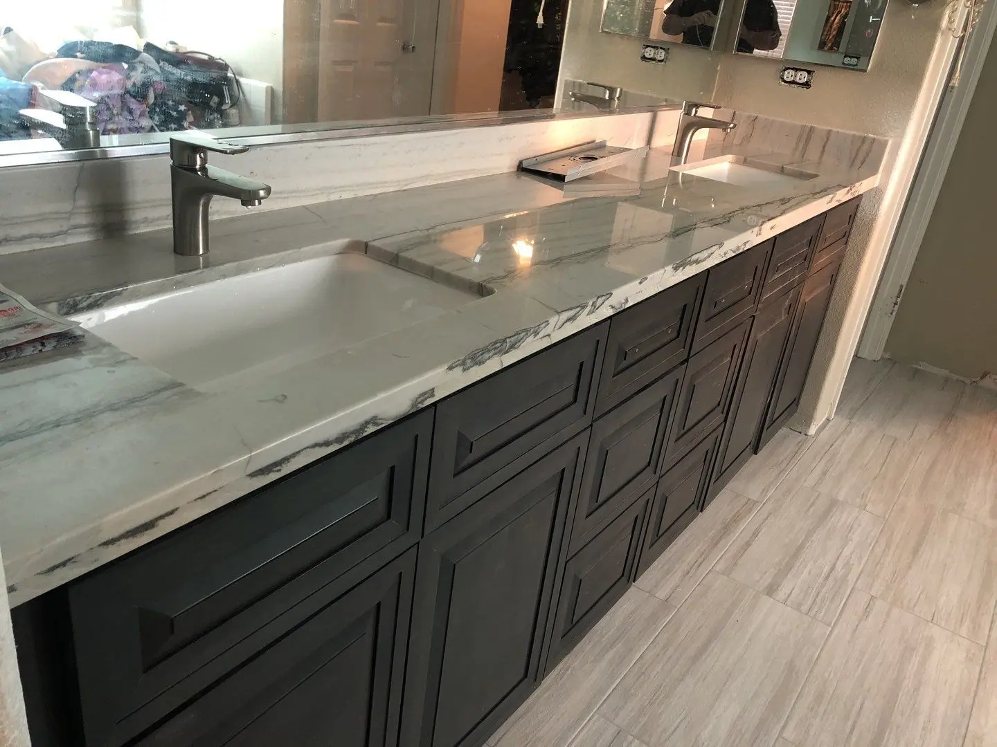 Finished bathroom vanity and flooring during Beaumont water damage restoration project by PL Builders