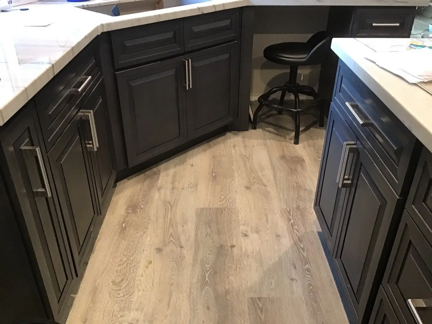 Finished kitchen flooring and island walkway during Beaumont water damage restoration project by PL Builders
