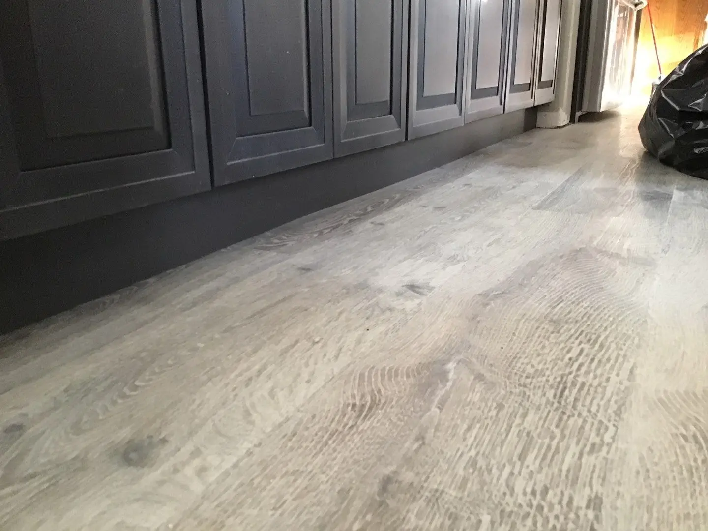 Finished SPC flooring and rebuilt cabinet area during Beaumont water damage restoration project by PL Builders