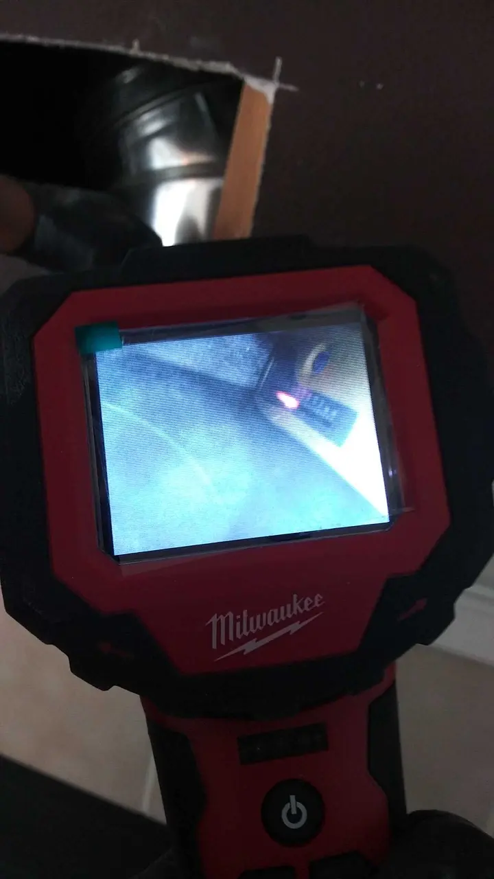 Inspection camera moisture review during Beaumont water damage restoration project by PL Builders