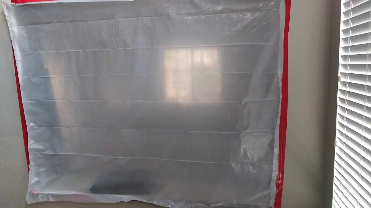 Plastic containment protecting the room during dry-out during Beaumont water damage restoration project by PL Builders