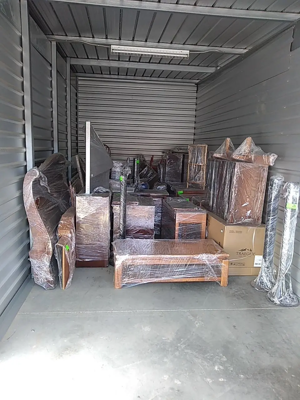 Wrapped contents organized in storage during Beaumont water damage restoration project by PL Builders