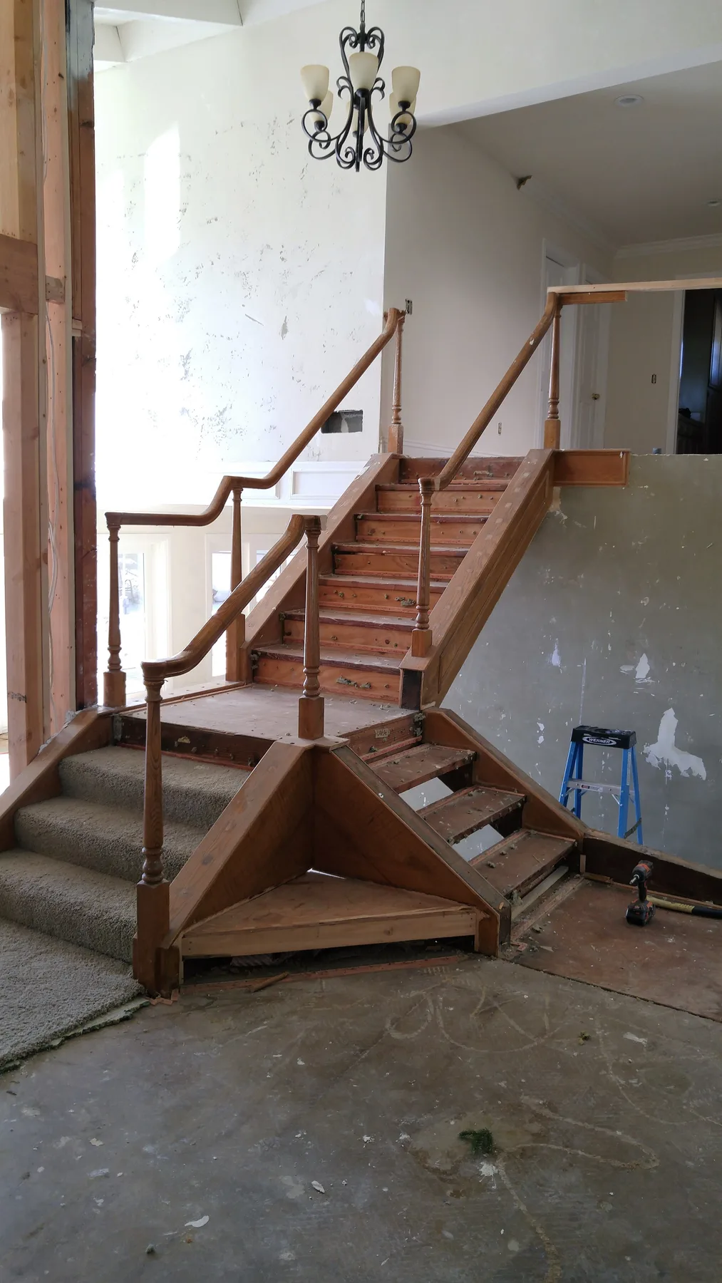 Corona custom stair rebuild project by PL Builders with wood posts and metal railing