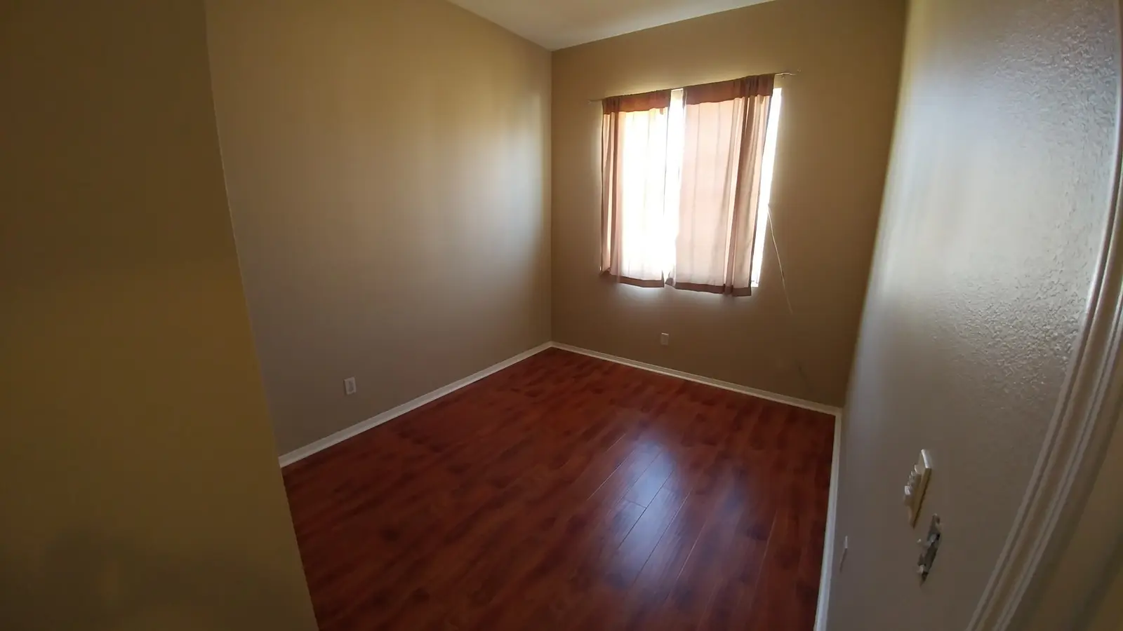 Jurupa Valley burst pipe kitchen water damage restoration project by PL Builders showing finished bedroom flooring after water damage repair