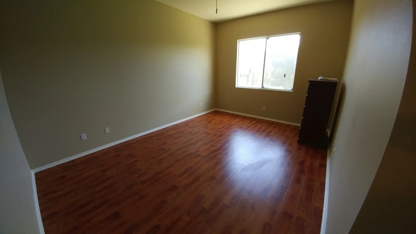 Jurupa Valley burst pipe kitchen water damage restoration project by PL Builders showing finished bedroom flooring and paint after water damage restoration