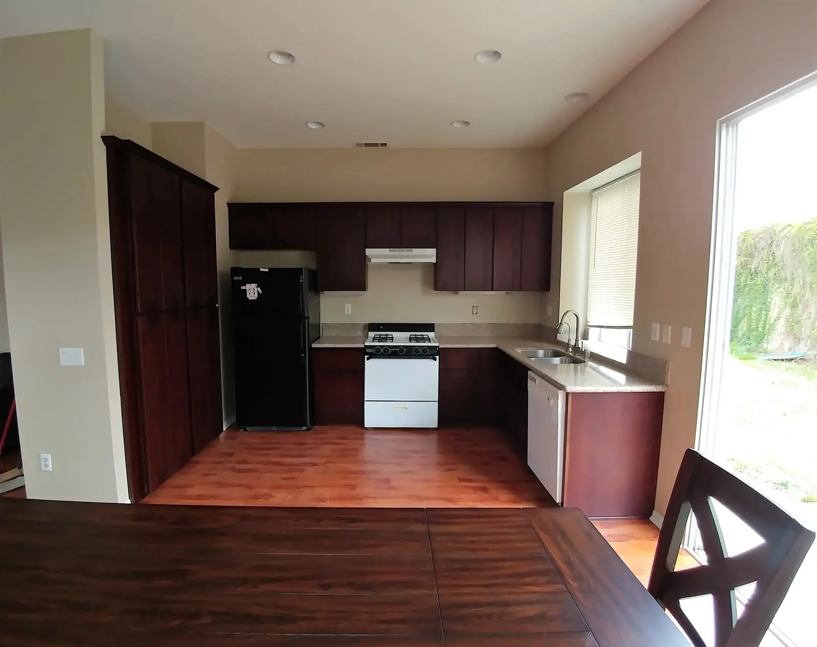 Jurupa Valley burst pipe kitchen water damage restoration project by PL Builders showing finished kitchen flooring and cabinet repair after burst pipe