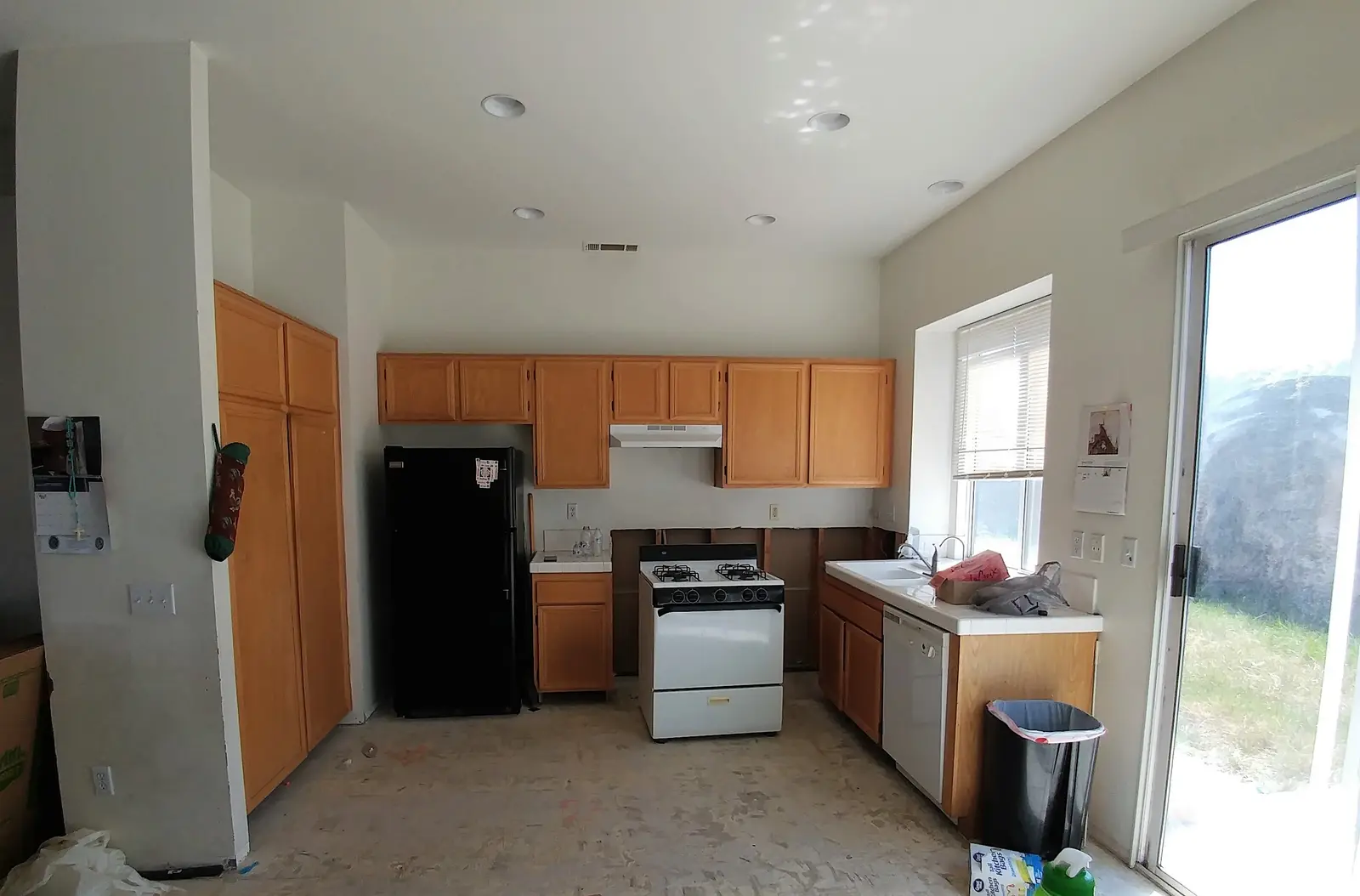 Jurupa Valley burst pipe kitchen water damage restoration project by PL Builders showing kitchen before burst pipe reconstruction with older cabinets