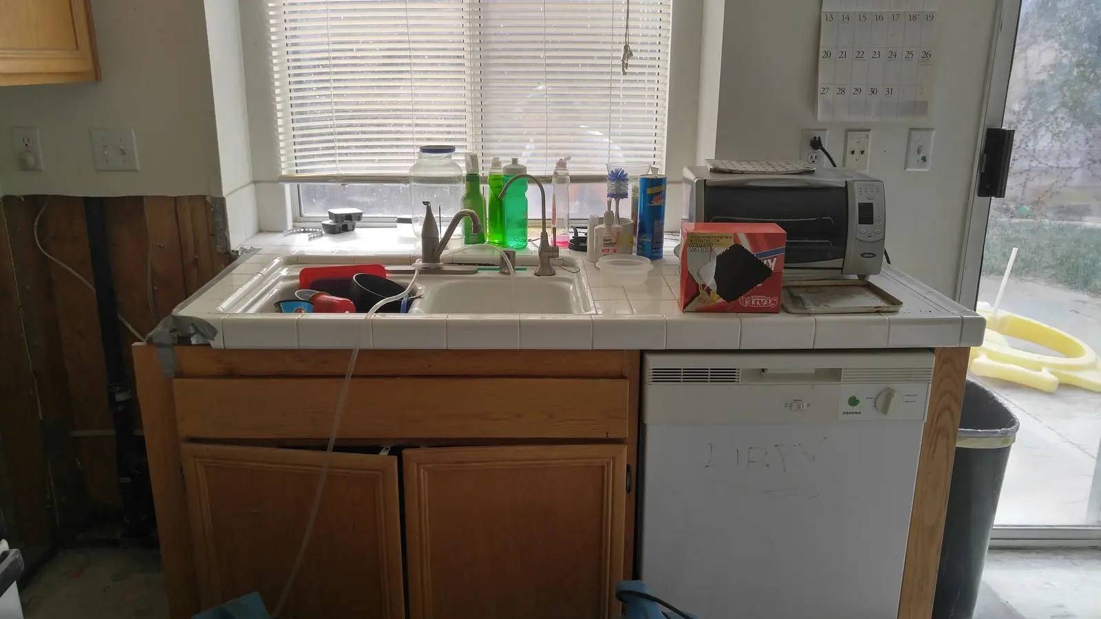 Jurupa Valley burst pipe kitchen water damage restoration project by PL Builders showing kitchen sink cabinet area documented after burst pipe leak