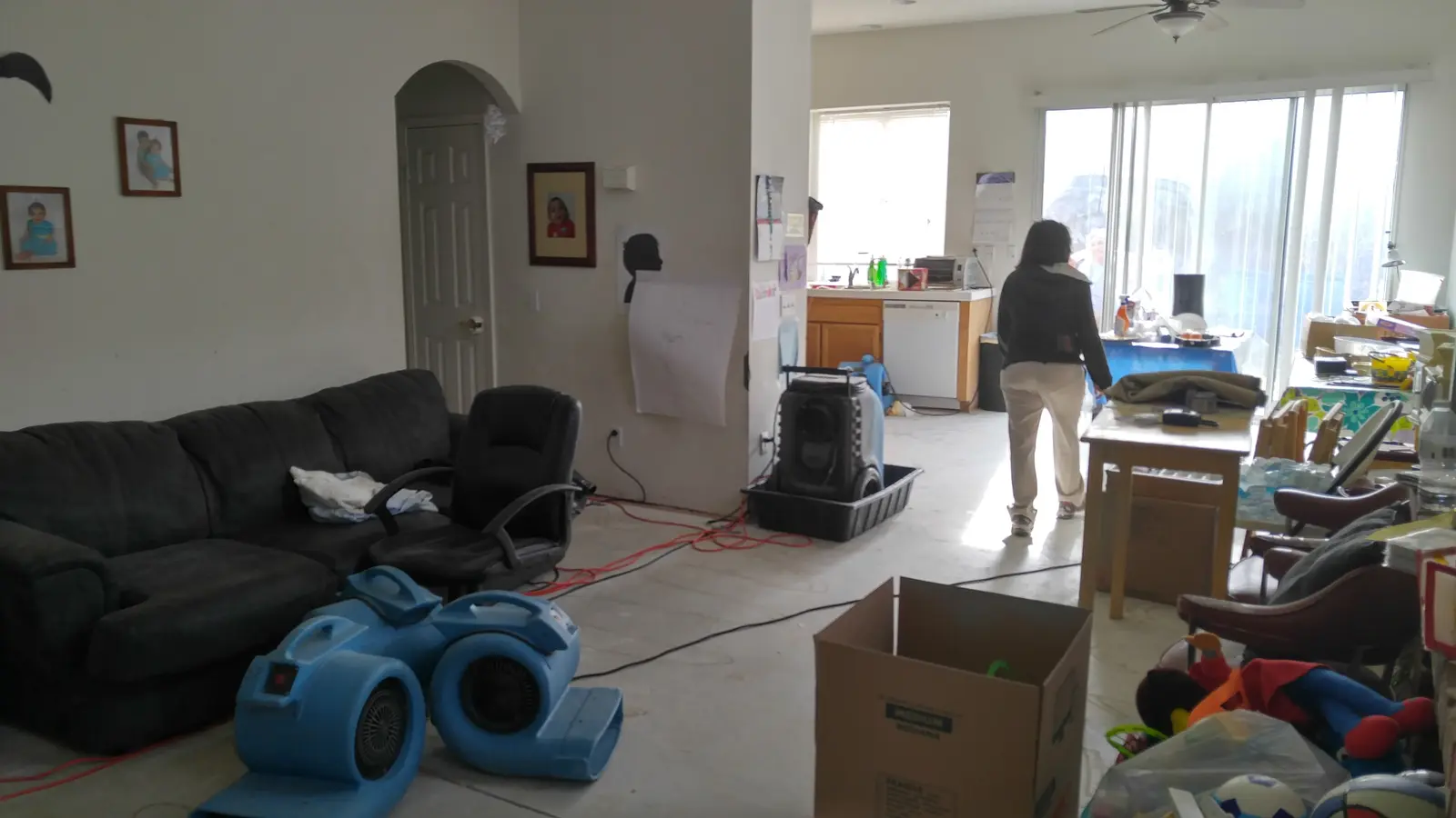 Jurupa Valley burst pipe kitchen water damage restoration project by PL Builders showing living room drying equipment after kitchen burst pipe water damage