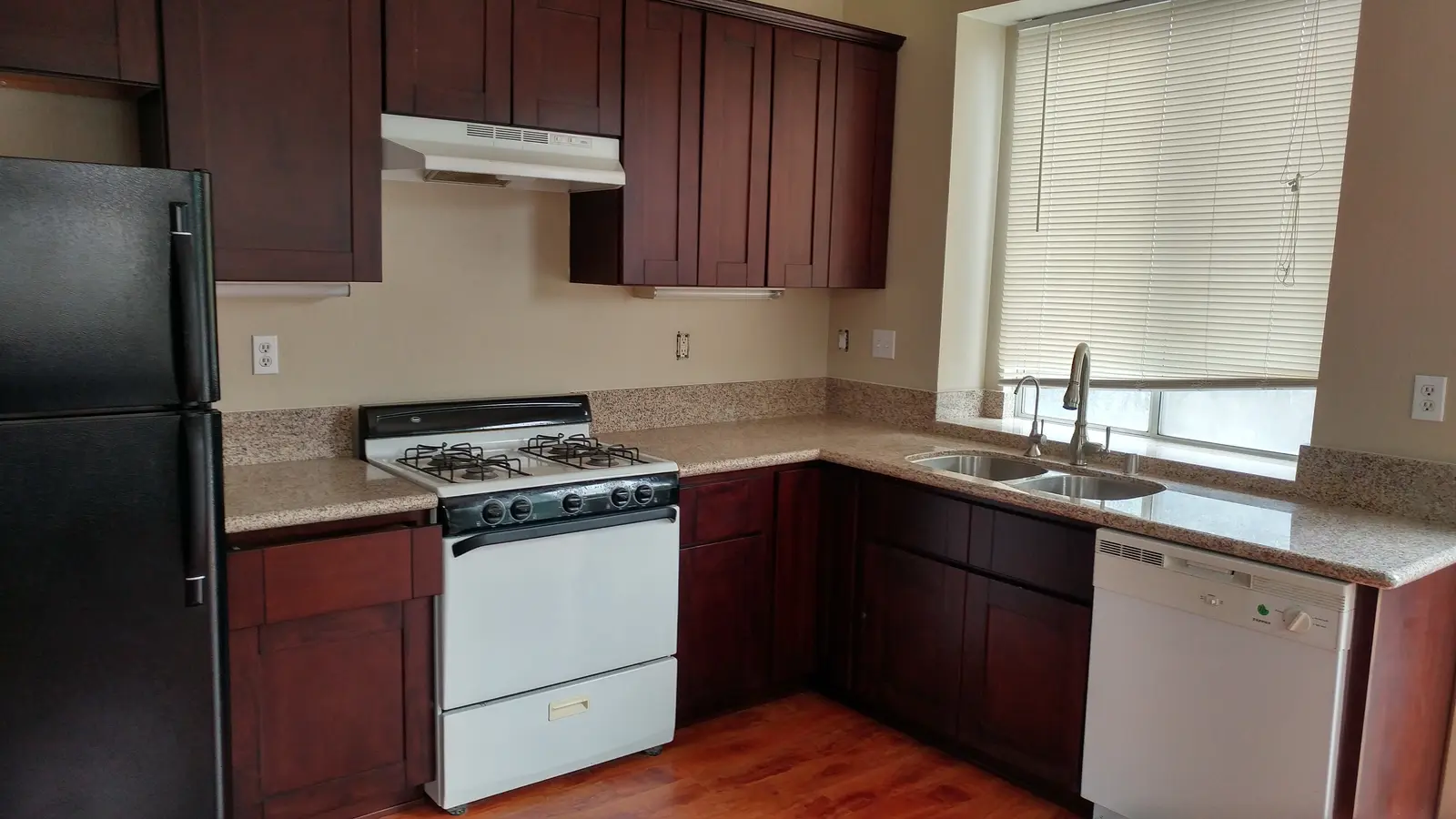 Jurupa Valley burst pipe kitchen water damage restoration project by PL Builders showing rebuilt kitchen cabinet and countertop area after burst pipe repair