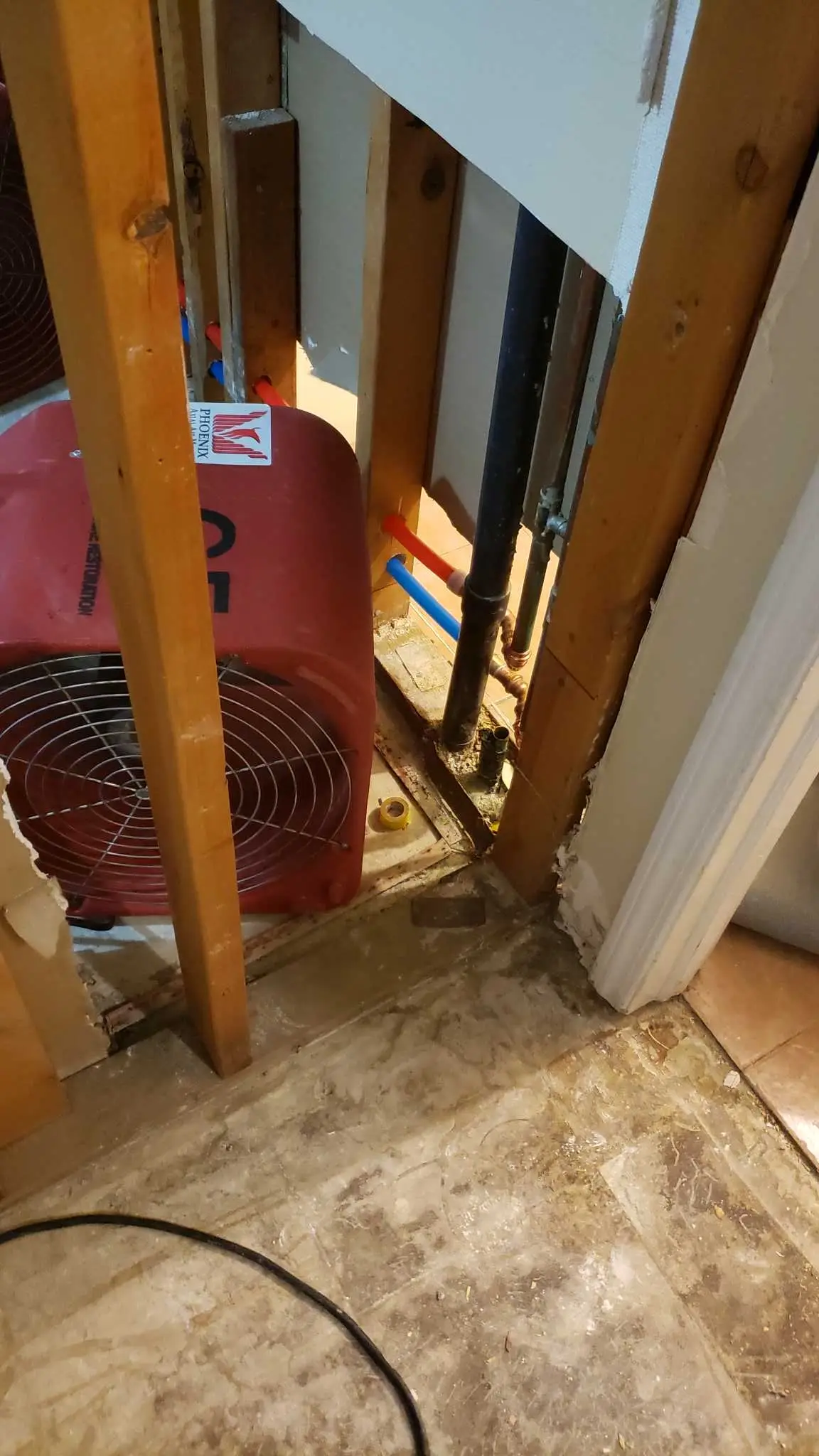 Lake Elsinore repipe water damage mitigation project by PL Builders showing air mover placed at open wall for structural drying
