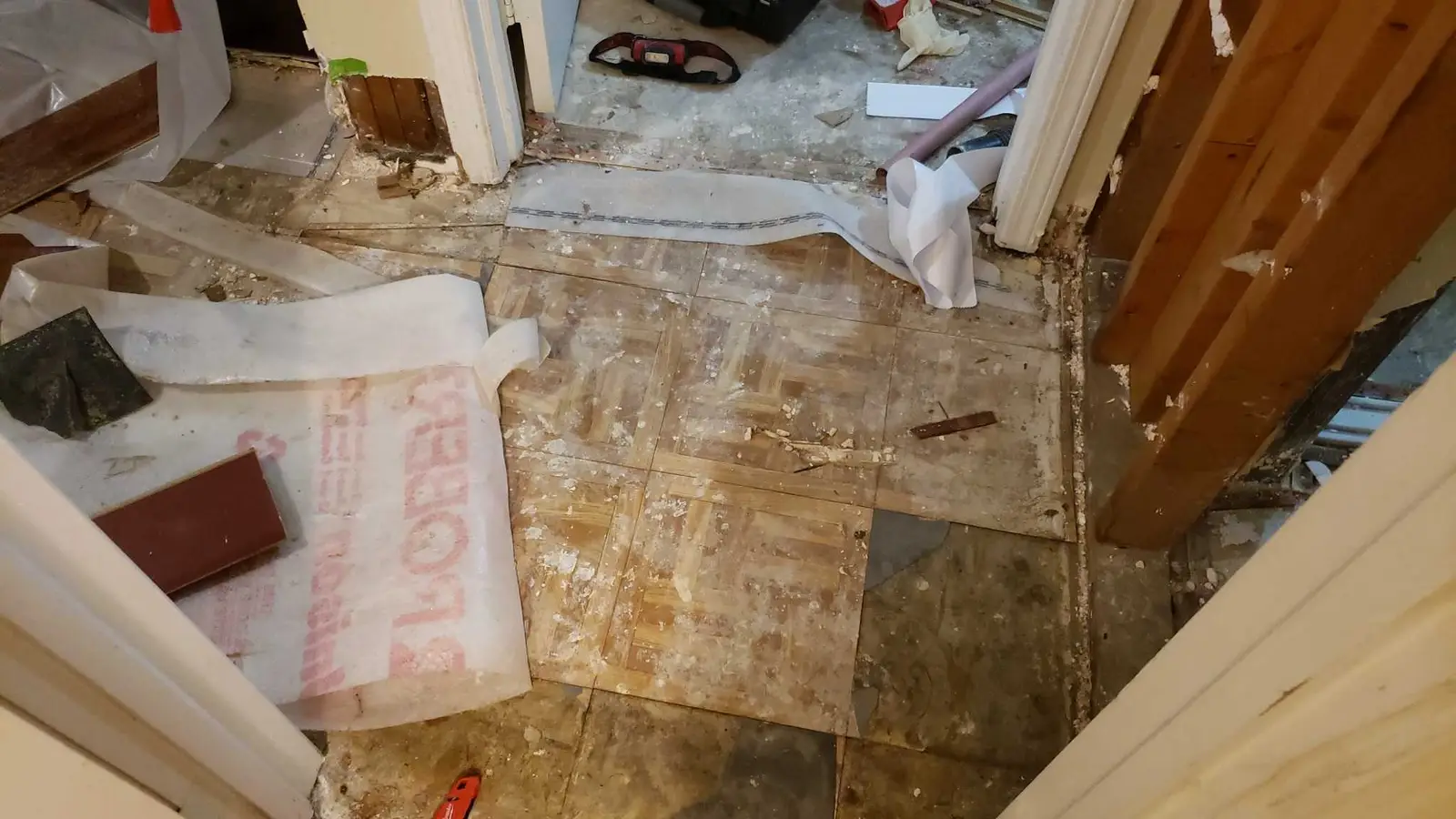 Lake Elsinore repipe water damage mitigation project by PL Builders showing flooring opened for drying access and documentation