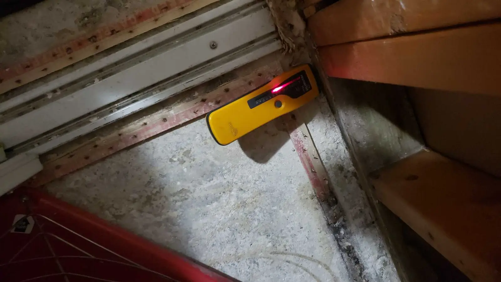 Lake Elsinore repipe water damage mitigation project by PL Builders showing moisture documentation at exposed floor edge