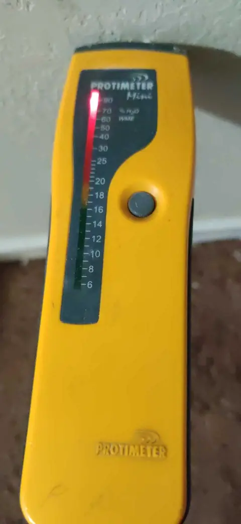Lake Elsinore repipe water damage mitigation project by PL Builders showing moisture meter reading at affected wall area