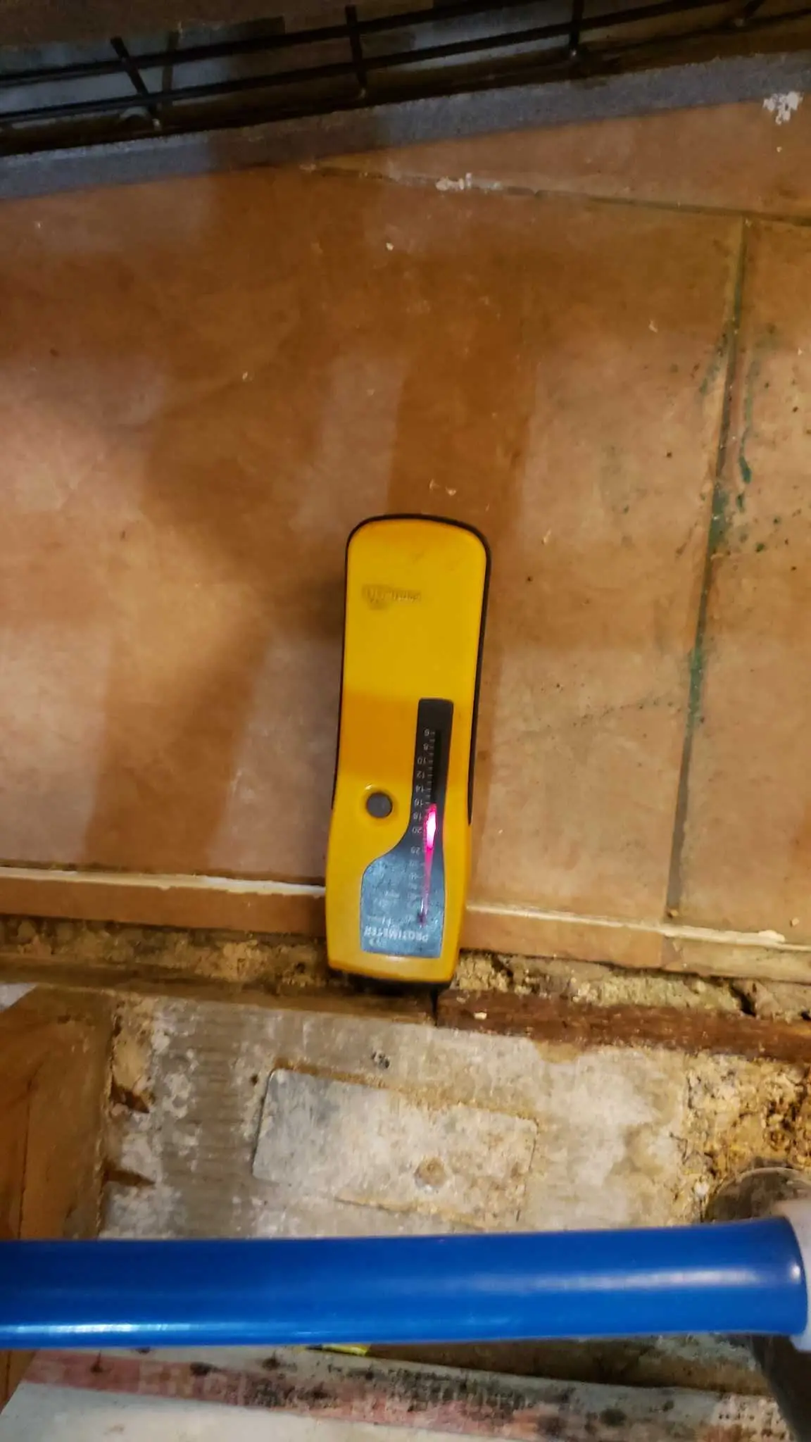 Lake Elsinore repipe water damage mitigation project by PL Builders showing moisture reading at tile and wall transition