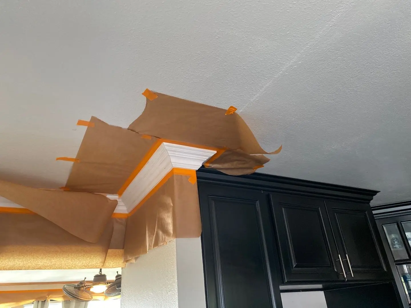 San Jacinto slab leak water damage repair by PL Builders showing kitchen ceiling and crown molding protection during drywall and paint work