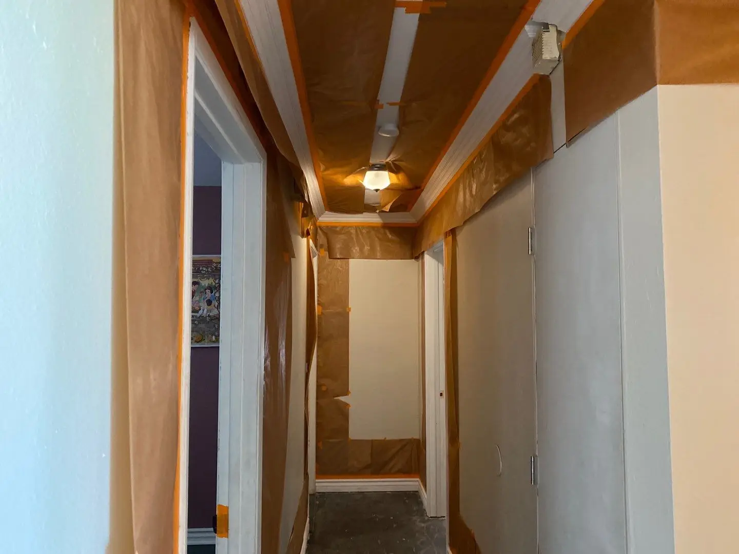 San Jacinto slab leak repair project by PL Builders showing protected hallway ceiling drywall repair area during finish work