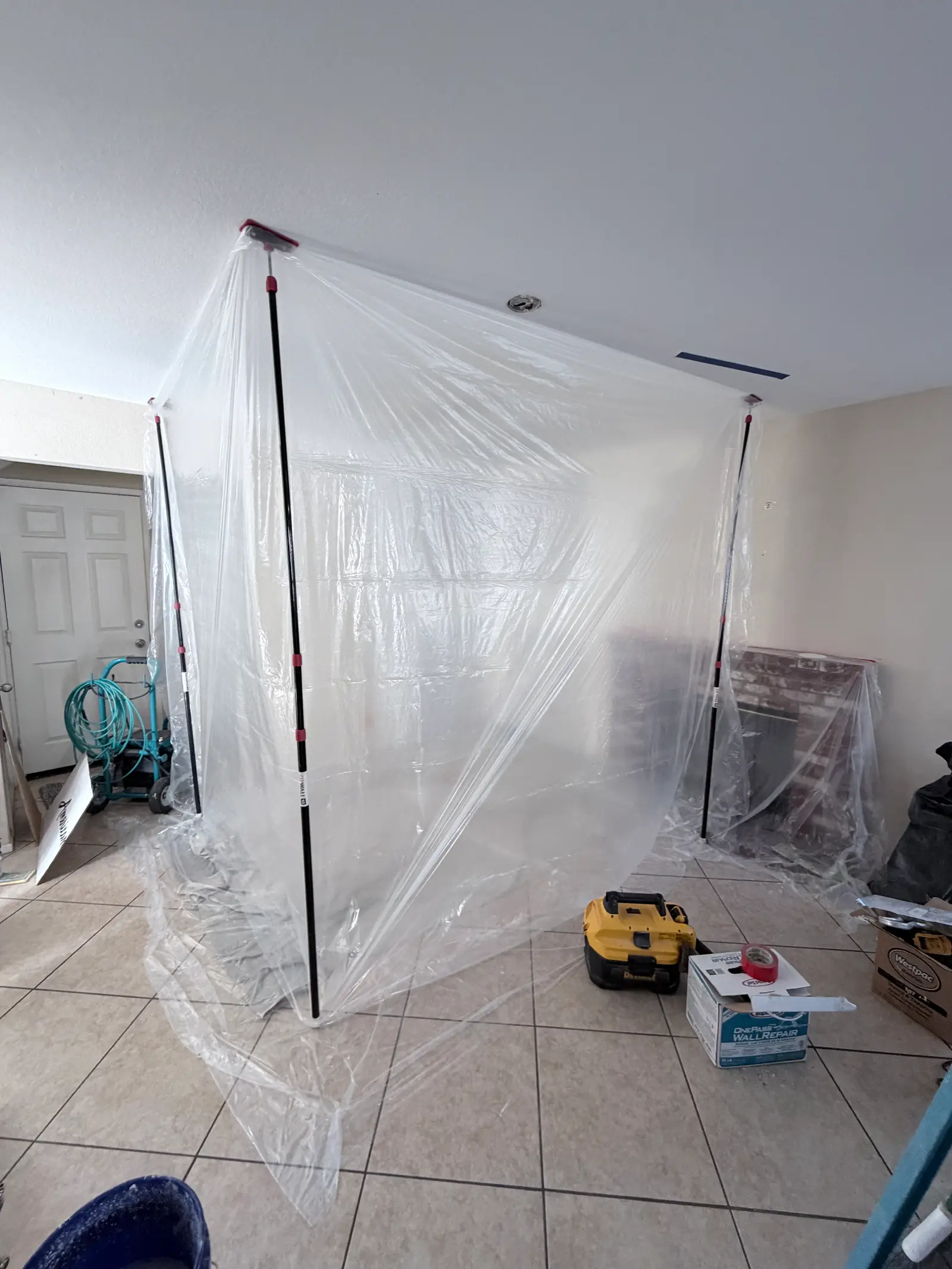 Bathroom containment and protection during mitigation during Temecula water damage restoration project by PL Builders