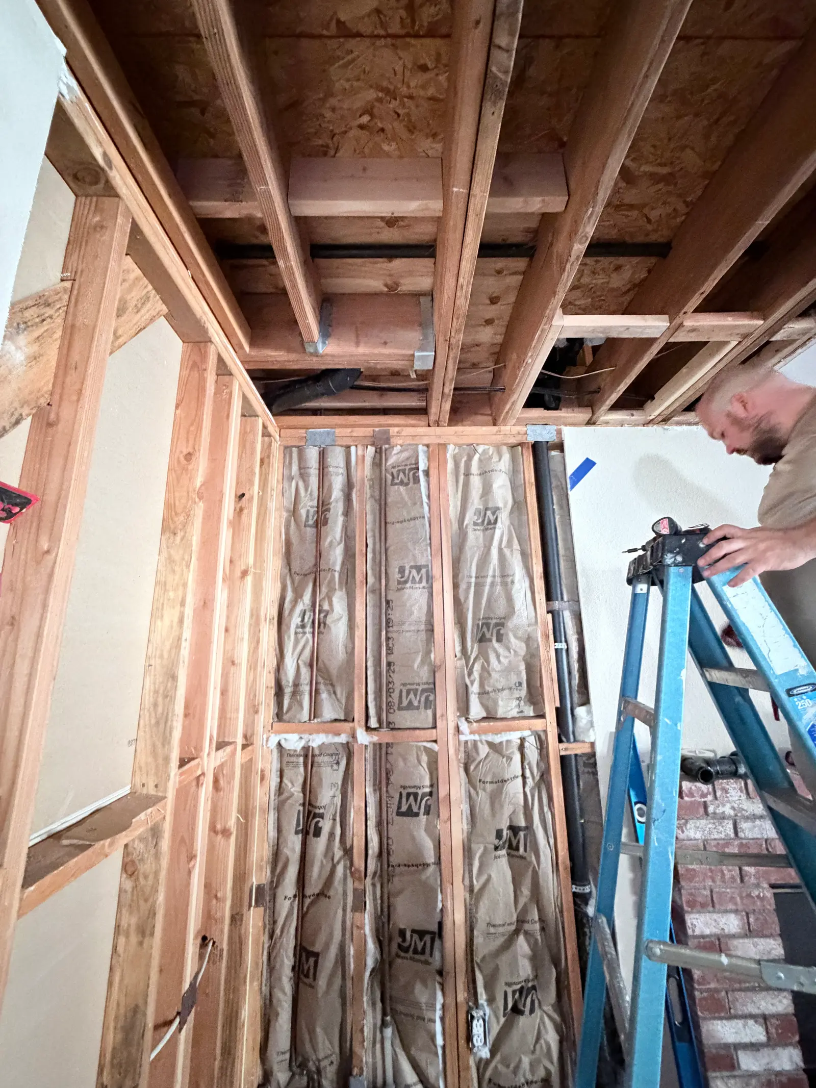 Bathroom framing exposed for water damage dry-out during Temecula water damage restoration project by PL Builders