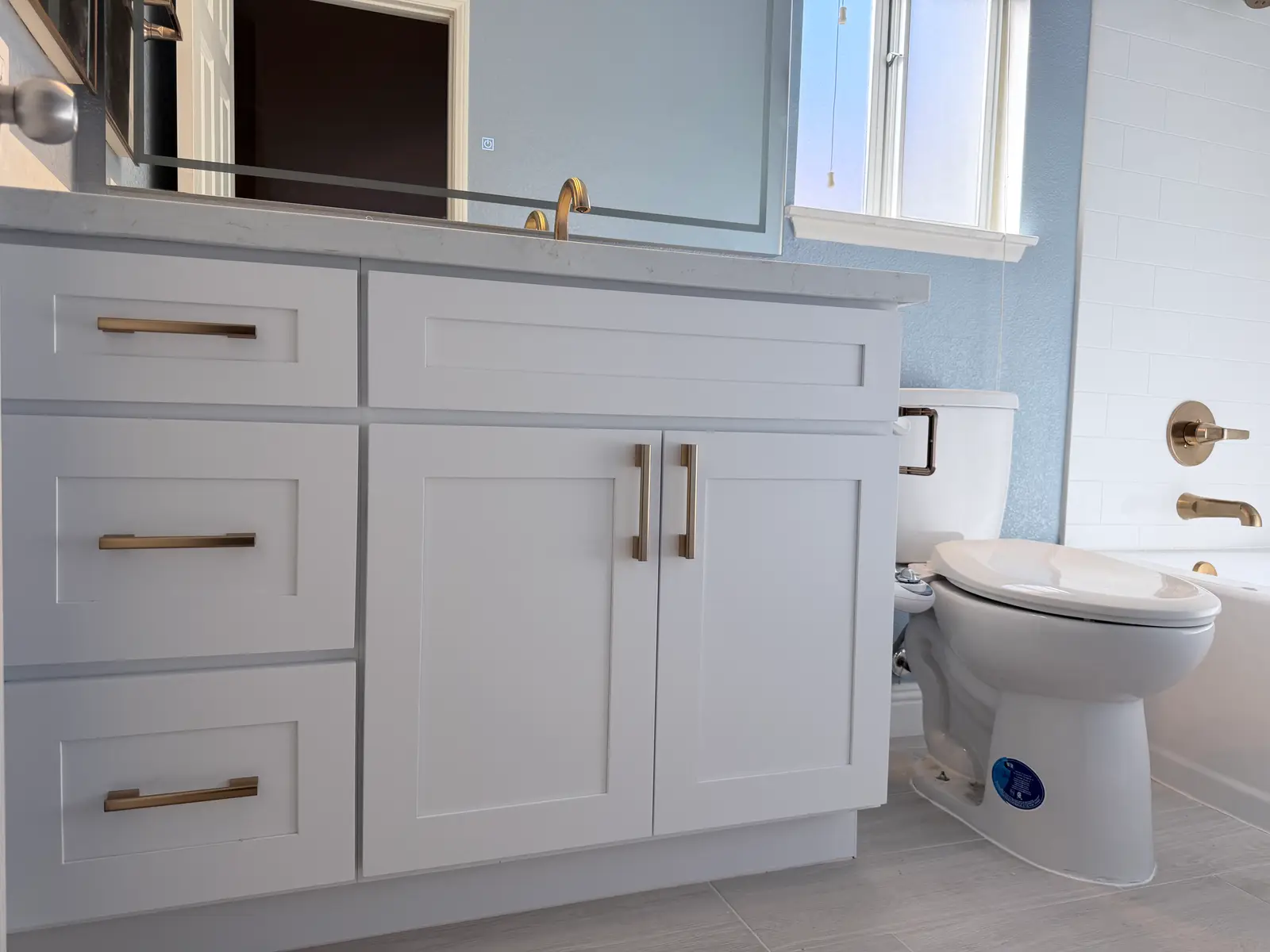 Bathroom vanity and flooring after reconstruction during Temecula water damage restoration project by PL Builders
