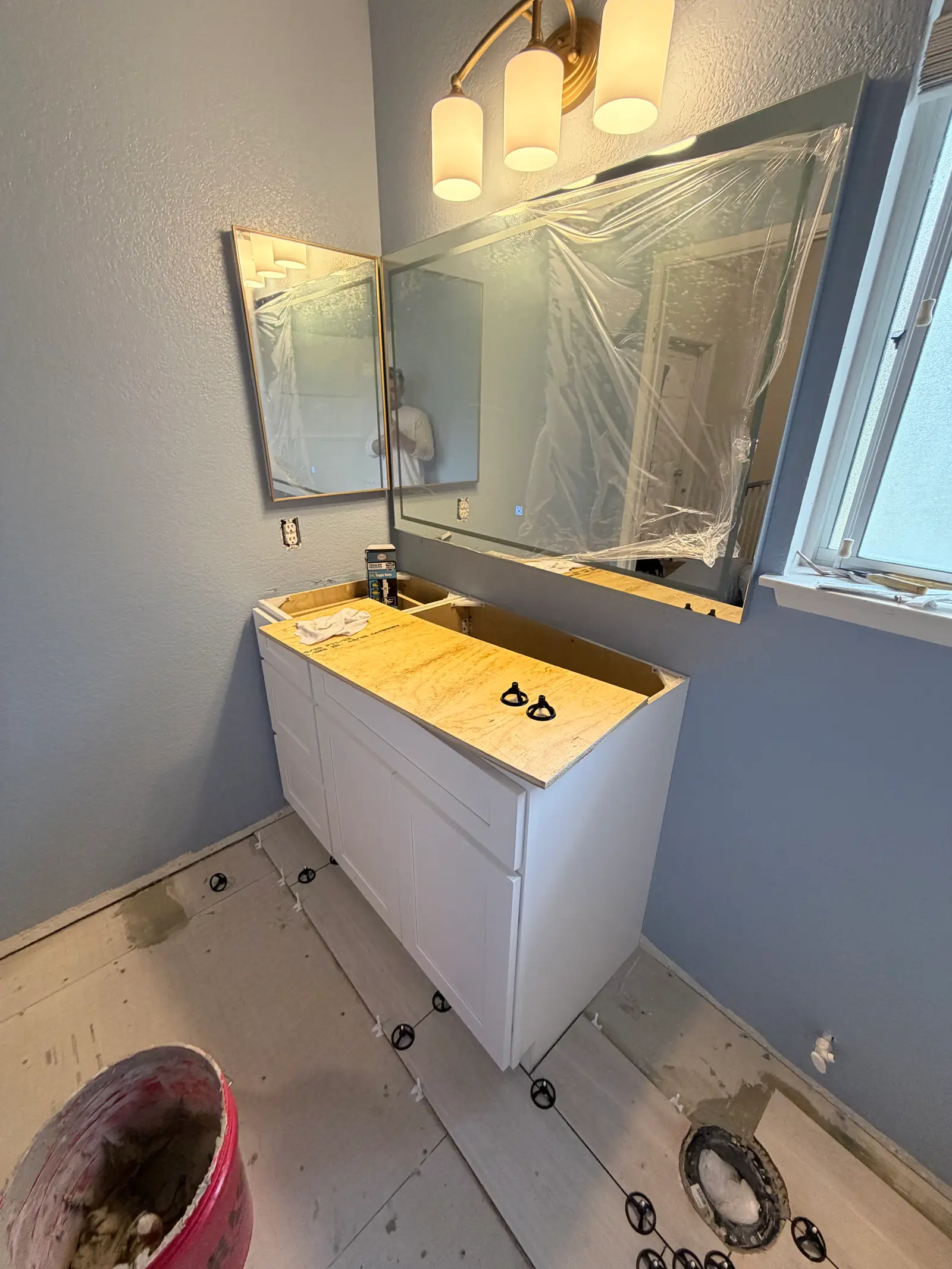 Bathroom vanity and wall finish detail during Temecula water damage restoration project by PL Builders