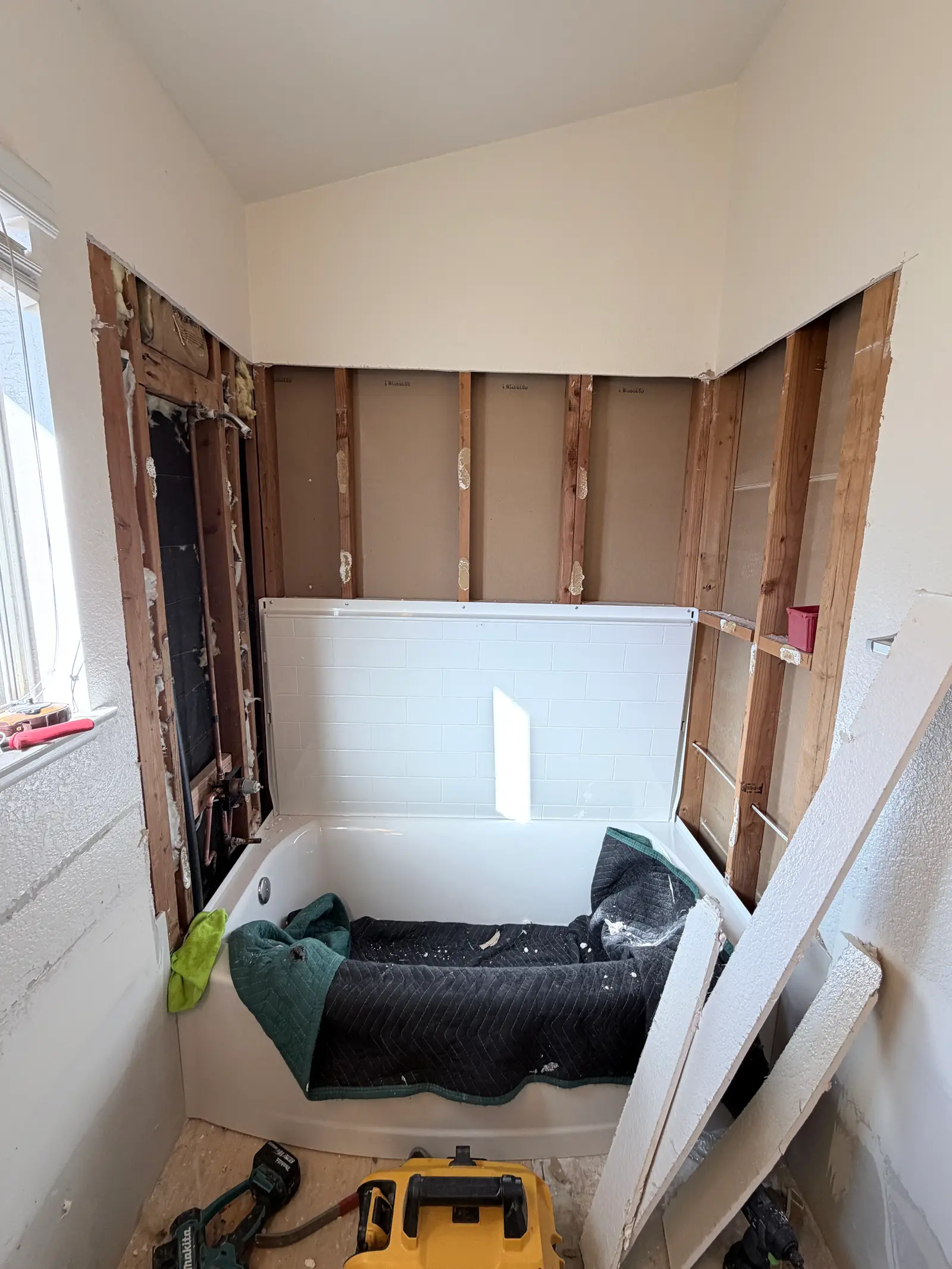 Bathroom wall repair progress after water damage during Temecula water damage restoration project by PL Builders
