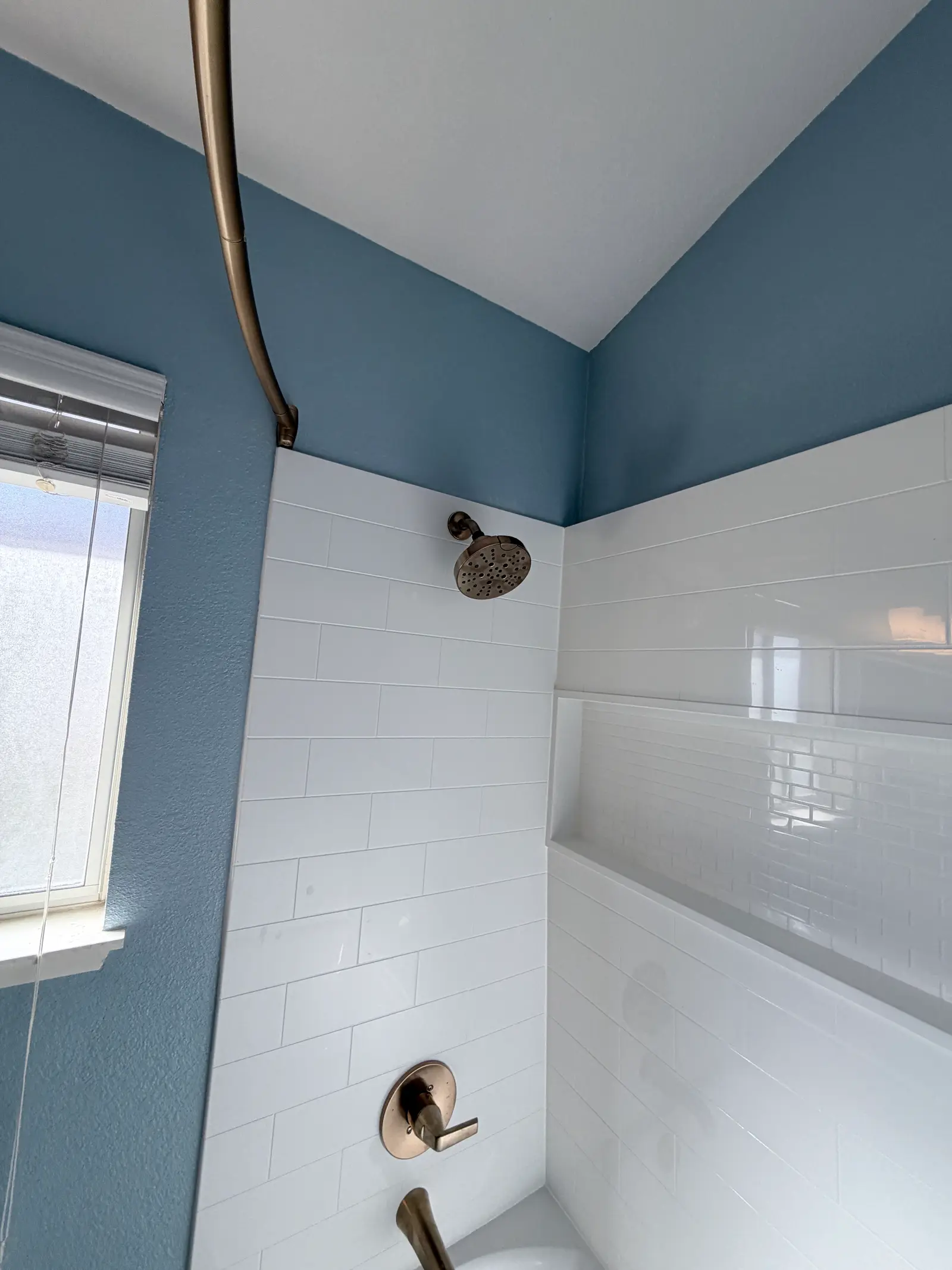 Finished bathroom wall and shower trim during Temecula water damage restoration project by PL Builders