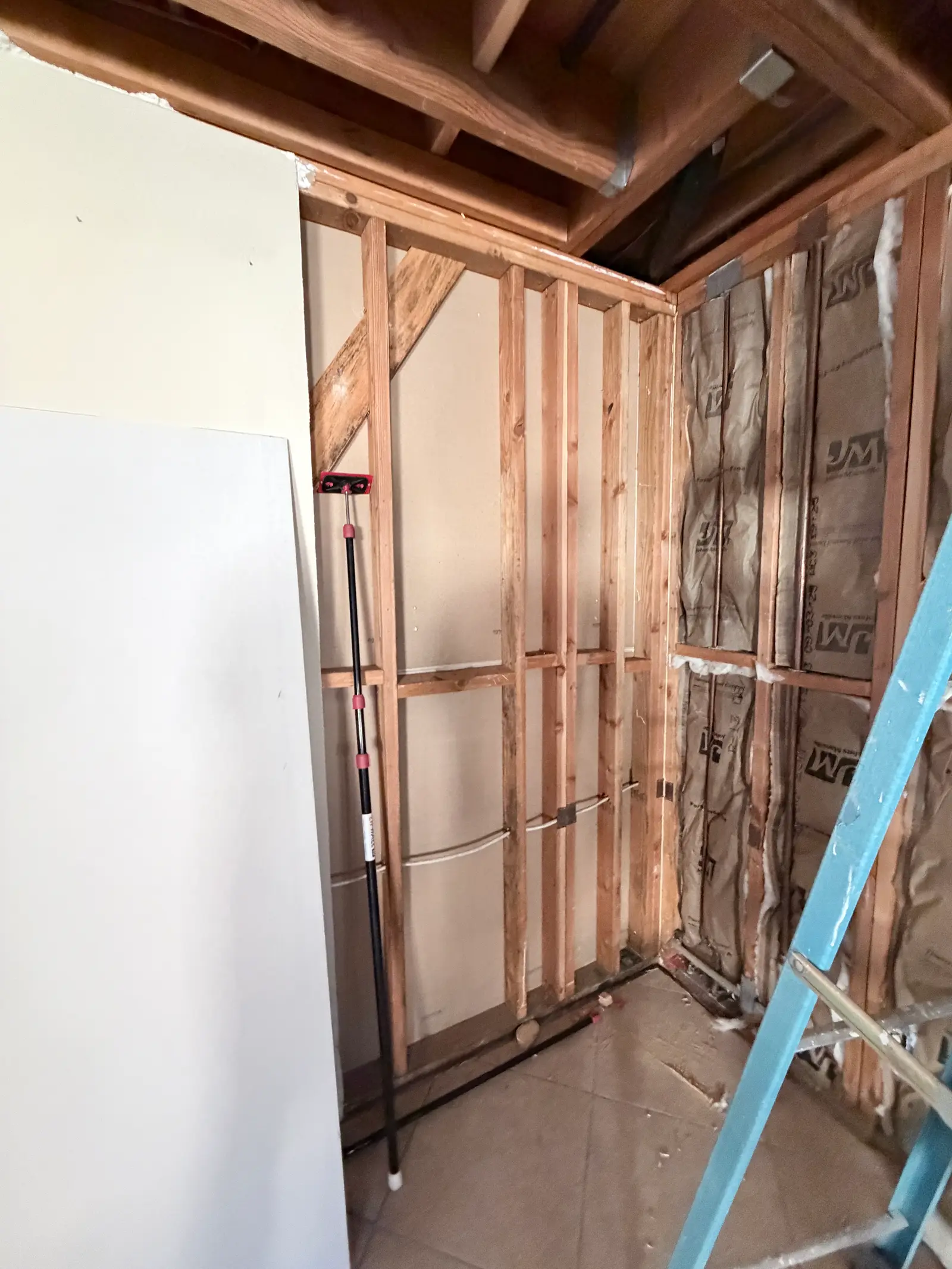 Opened bathroom wall: Temecula water damage restoration project by PL Builders showing Broken Toilet Drain Water Damage Restoration