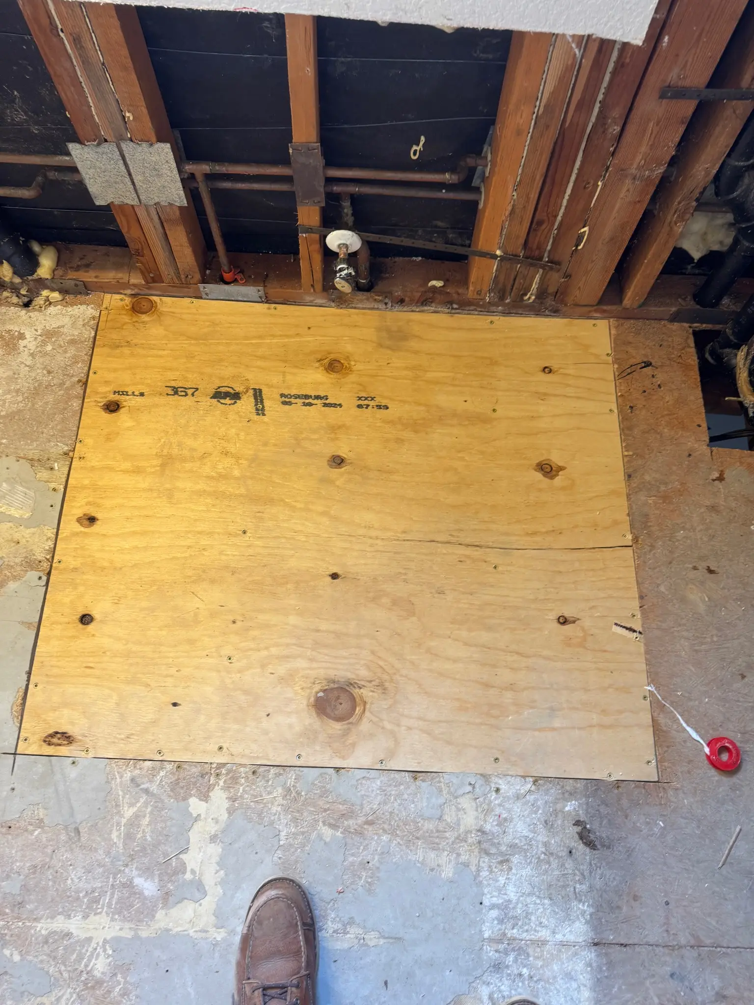 Subfloor patched after bathroom drain repair during Temecula water damage restoration project by PL Builders