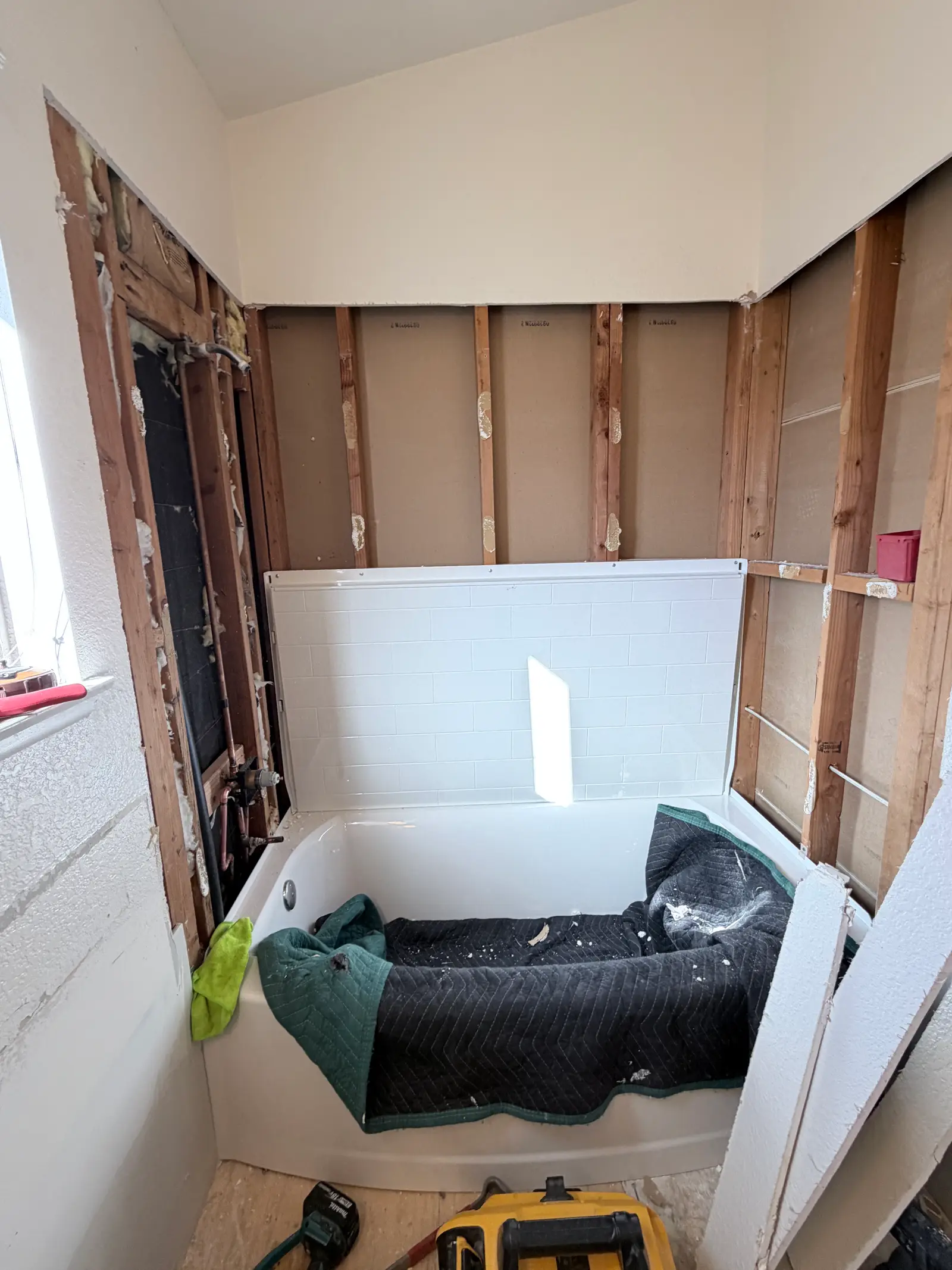 Tub wall opened during water damage repair during Temecula water damage restoration project by PL Builders