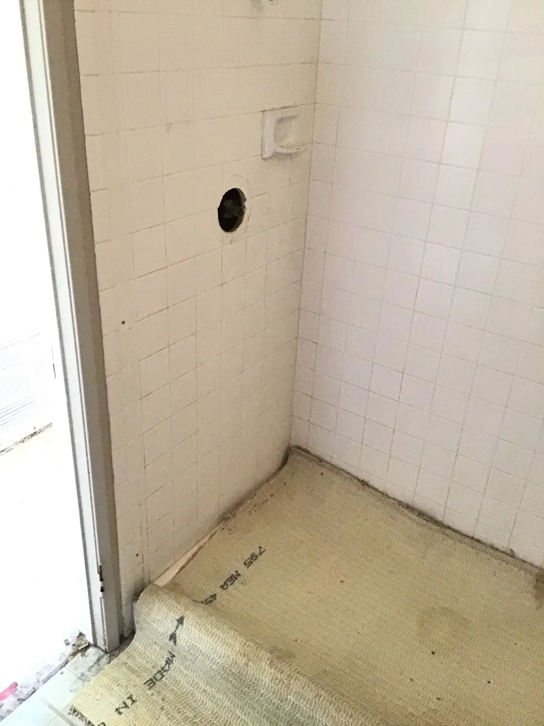 Documented damaged flooring, shower, or wall area 261 during Temecula water damage restoration project by PL Builders