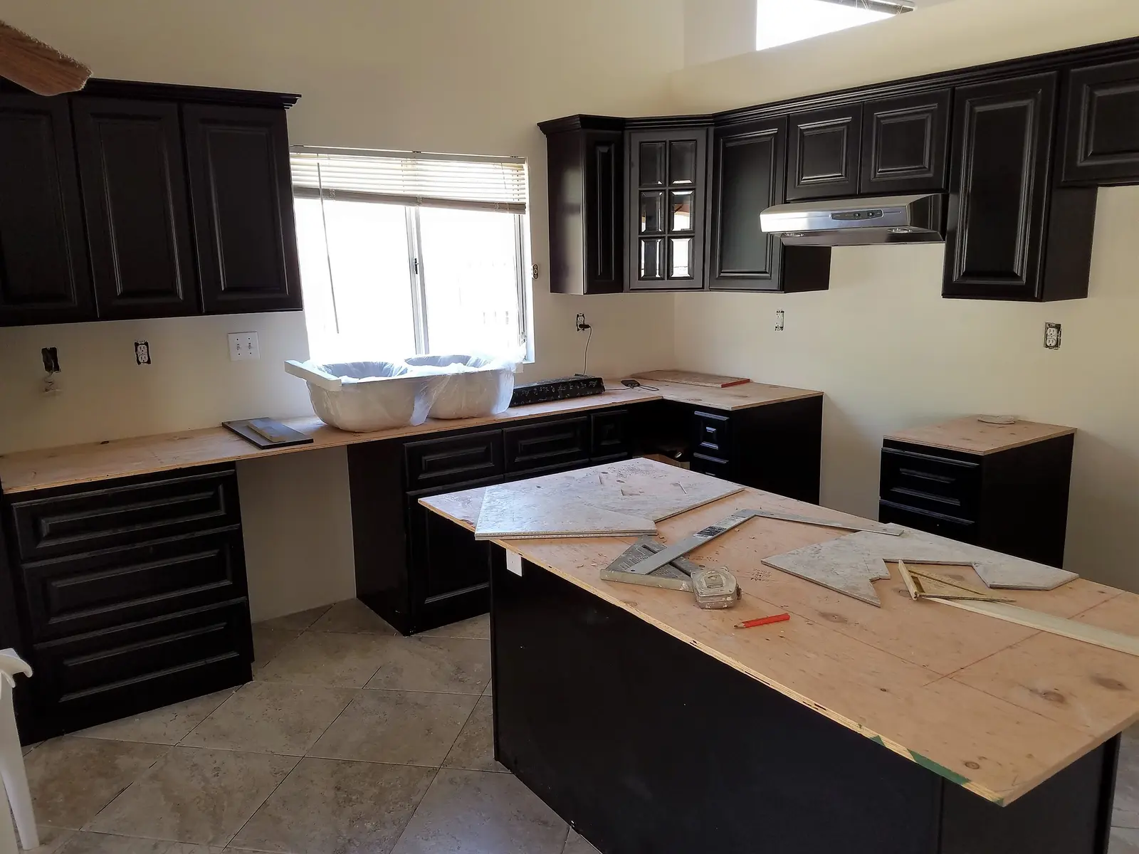 Wildomar slab leak kitchen water damage repair project by PL Builders showing finished kitchen cabinets and island after slab leak repair
