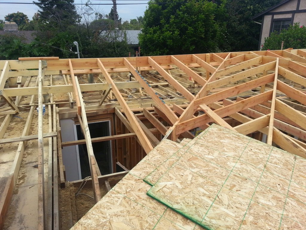 Before: New sheathing and siding installed after fire restoration in Fontana garage